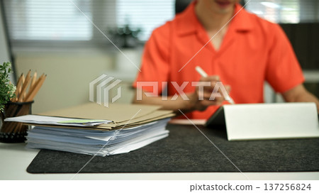 Focus with Stack of Documents paper folders on office desk Focus with Stack of Documents paper folders on office desk 137256824