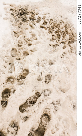 The Architecture backgrounds and objects. Footprints in the dirty snow. The Architecture backgrounds and objects. Footprints in the dirty snow. 137257041