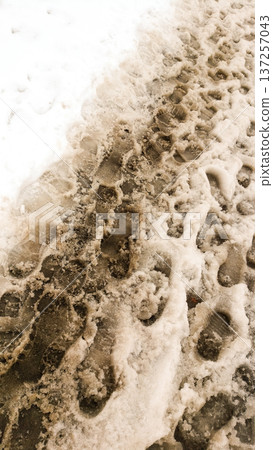 The Architecture backgrounds and objects. Footprints in the dirty snow. The Architecture backgrounds and objects. Footprints in the dirty snow. 137257043
