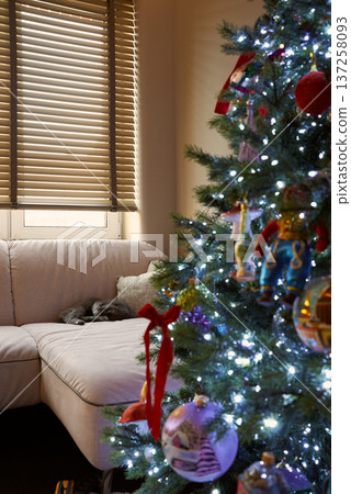 Warm and inviting display of festive glass baubles and ribbons 137258093
