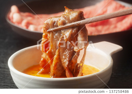 Sukiyaki (Japanese Black Beef) dipped in beaten egg Sukiyaki (Japanese Black Beef) dipped in beaten egg 137258486