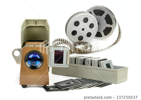Vintage slide projector with film strips and photographic slides. 137258537