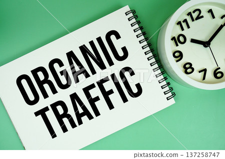 Organic Traffic text with alarm clock flat lay on green background Organic Traffic text with alarm clock flat lay on green background 137258747