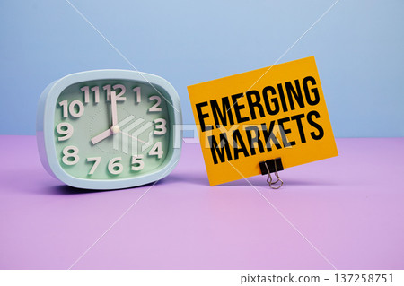Emerging Markets text and alarm clock on blue and purple background Emerging Markets text and alarm clock on blue and purple background 137258751