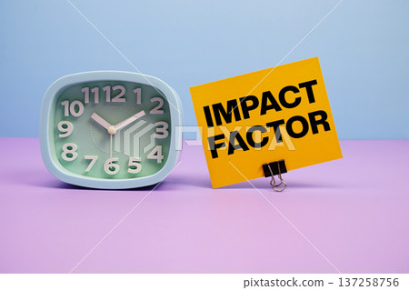 Impact Factor text and alarm clock on blue and purple background 137258756