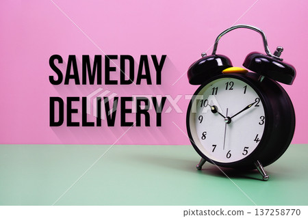 Black alarm clock on a pastel green and pink background with the text "Same Day Delivery" 137258770