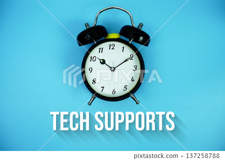Tech Supports text and alarm clock on blue background Tech Supports text and alarm clock on blue background 137258788