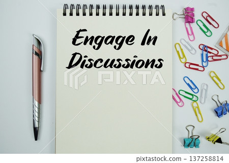 Engage In Discussions text message written on notepad with stationery flat lay on white background Engage In Discussions text message written on notepad with stationery flat lay on white background 137258814