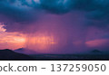 Dramatic rainstorm at sunset over mountain range. Heavy rainfall with colorful sky and clouds. Scenic landscape view. 137259050