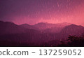 Atmospheric mountain range landscape with heavy rain and dramatic purple and pink sky at dusk or dawn. 137259052