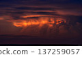 Dramatic and colorful sunset with storm clouds. Beautiful cloudscape with orange and dark colors. Weather phenomenon. 137259057
