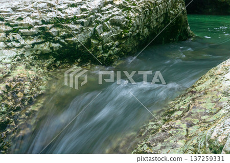 mountain stream in the canyon, blurred in motion mountain stream in the canyon, blurred in motion 137259331