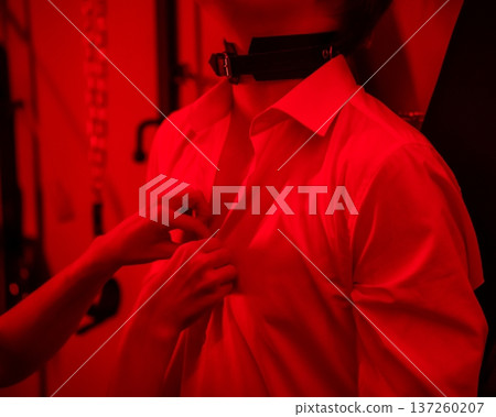 A woman undresses a tied-up man. Role-playing games. A woman undresses a tied-up man. Role-playing games. 137260207