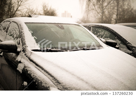 Heated glass on a modern snow-covered car. High quality photo Heated glass on a modern snow-covered car. High quality photo 137260230