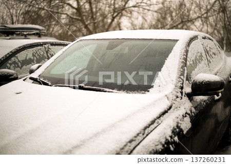 Heated glass on a modern snow-covered car. High quality photo Heated glass on a modern snow-covered car. High quality photo 137260231