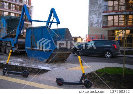 Construction garbage container in the yard of the house. High quality photo Construction garbage container in the yard of the house. High quality photo 137260232