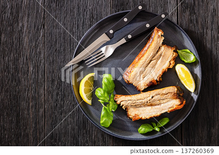 Roasted pork belly ribs with pesto and lemon Roasted pork belly ribs with pesto and lemon 137260369
