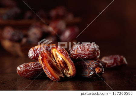 Dates fruit on an old wooden table. 137260593