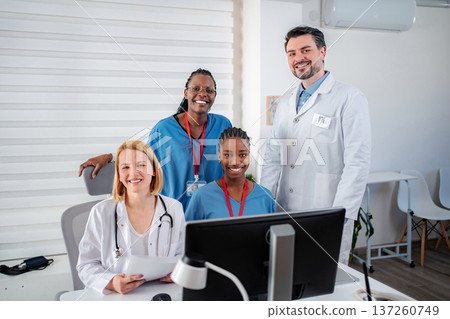 Diverse medical team smiling in modern clinic office Diverse medical team smiling in modern clinic office 137260749