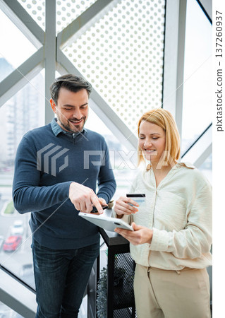 Business partners making online payment using tablet and credit card 137260937