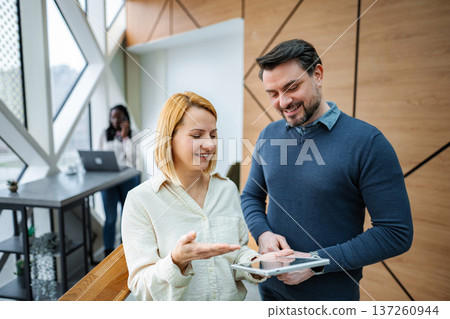Business colleagues collaborating using digital tablet in office Business colleagues collaborating using digital tablet in office 137260944