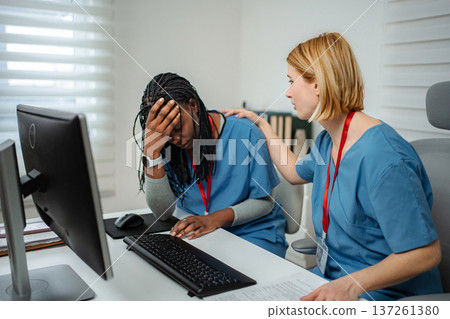 Healthcare worker experiencing burnout with supportive colleague 137261380