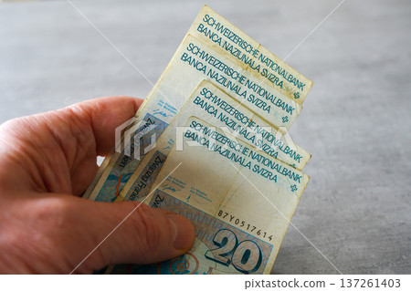 Hand Holding Swiss Franc Banknotes Financial Cash and Currency Concept Hand Holding Swiss Franc Banknotes Financial Cash and Currency Concept 137261403