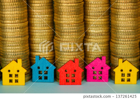 Colorful Miniature Houses in Front of Coin Stacks Real Estate Investment Concept Colorful Miniature Houses in Front of Coin Stacks Real Estate Investment Concept 137261425