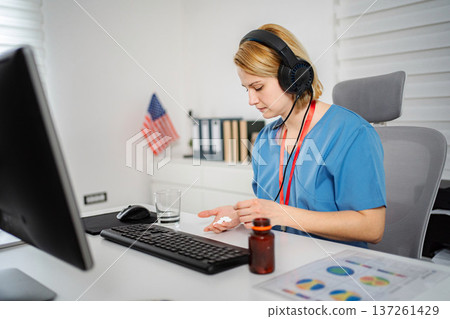 Female nurse medic taking daily vitamins or pills 137261429