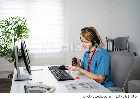 Nurse taking medication experiencing work stress burnout 137261430