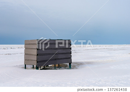 Beach Changing Cabin Surrounded by Snow on Baltic Sea Coast in Winter 137261438