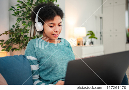 Young woman learning online with headphones and laptop 137261478