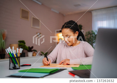 Young girl learning and writing during homework time 137261632