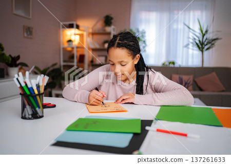 Girl drawing creative art on colorful paper at home Girl drawing creative art on colorful paper at home 137261633