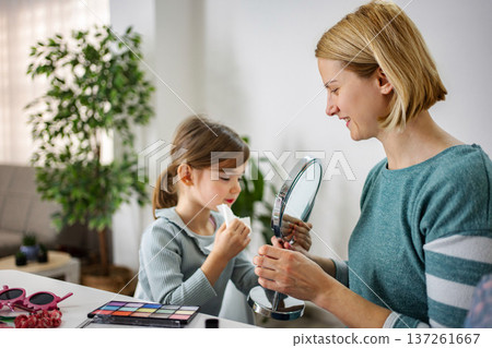 Mother daughter bonding while applying makeup at home Mother daughter bonding while applying makeup at home 137261667