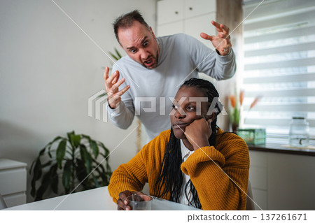Frustrated man screaming at bored young woman during conflict 137261671