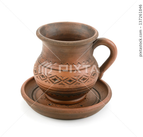Rustic Clay Mug with Saucer Featuring Geometric Patterns Isolated on White Background Rustic Clay Mug with Saucer Featuring Geometric Patterns Isolated on White Background 137261846