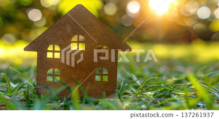 House silhouette on grass with sunlight in background represents home concept 137261937