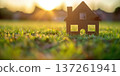 Set in a calm evening, a small model house stands on lush green grass 137261941