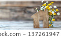 Wooden house symbol and fresh flowers creating a cozy home atmosphere 137261947