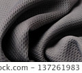 Close-up of a gray textured fabric commonly used for moisture-wicking athletic jerseys. 137261983