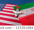 The airplane is placed on top of the flags of the United States and Iran. 137261984