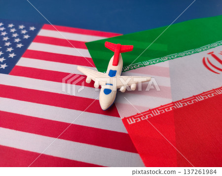 The airplane is placed on top of the flags of the United States and Iran. The airplane is placed on top of the flags of the United States and Iran. 137261984