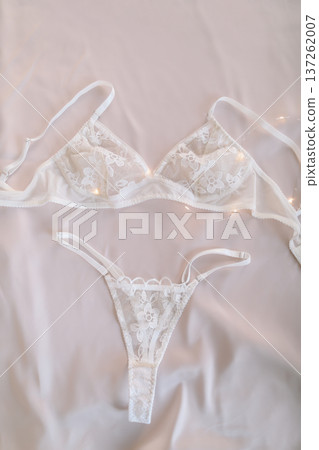Woman's lingerie on the bed sheets. Lace sexy female underwear. Beauty, fashion blogger concept. Female bra, panties, erotic clothes. Lingerie advertising Woman's lingerie on the bed sheets. Lace sexy female underwear. Beauty, fashion blogger concept. Female bra, panties, erotic clothes. Lingerie advertising 137262007