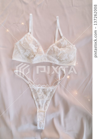 Woman's lingerie on the bed sheets. Lace sexy female underwear. Beauty, fashion blogger concept. Female bra, panties, erotic clothes. Lingerie advertising Woman's lingerie on the bed sheets. Lace sexy female underwear. Beauty, fashion blogger concept. Female bra, panties, erotic clothes. Lingerie advertising 137262008