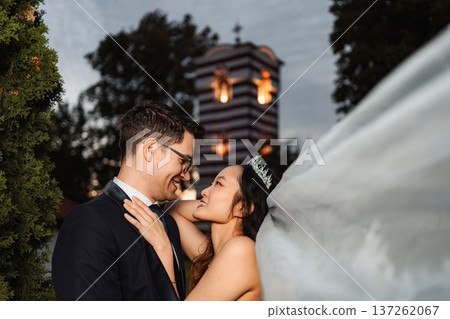 Bride and groom embracing outdoors during wedding reception Bride and groom embracing outdoors during wedding reception 137262067