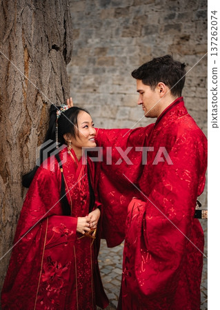 Interracial couple celebrating traditional Chinese wedding wearing hanfu Interracial couple celebrating traditional Chinese wedding wearing hanfu 137262074