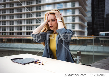 Stressed businesswoman experiencing burnout and work pressure in city Stressed businesswoman experiencing burnout and work pressure in city 137262088