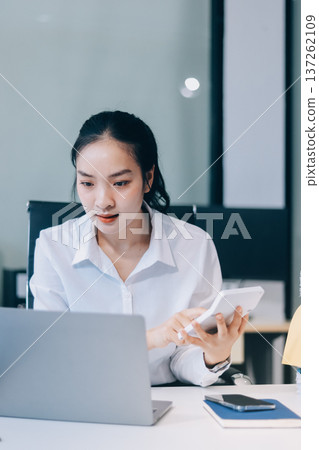 Asian business woman experiences work stress headache in modern office reviewing financial report data analysis overwhelmed professional employee burnout difficult project Asian business woman experiences work stress headache in modern office reviewing financial report data analysis overwhelmed professional employee burnout difficult project 137262109