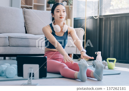 Young Asian sporty attractive people practicing yoga lesson with instructor. Asia group of women exercising healthy lifestyle in fitness studio. Sport activity, gymnastics or ballet dancing class. 137262181